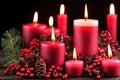 Red candles and red plant fruits for festive holiday celebration