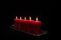 Red candles in a row burning Royalty Free Stock Photo