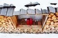 Red candles, wood logs and snow in Dolomity mountains, winter image Royalty Free Stock Photo