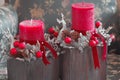 Red candles and wooden Santa deers in Christmas table decoration Royalty Free Stock Photo