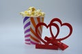 Red candlesticks and popcorn in striped cup