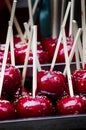 Red candy apple on holiday fair market closeup.