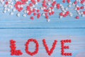 Red candy hearts laying on light blue painted rustic wooden background Royalty Free Stock Photo