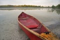 Red Canoe Beached On Lake