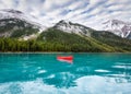 Red canoe floating on Maligne Lake with Rocky Mountains in Jasper national park Royalty Free Stock Photo