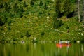 Red Canoe on Lake Reflecting Green Royalty Free Stock Photo