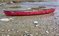 Red canoe at low tide Royalty Free Stock Photo