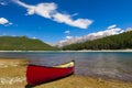 Red Canoe on the shore of a mountain lake Royalty Free Stock Photo