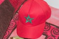 A red cap with the sign of the national famous Moroccan flag with a green star on a monotonous red background. National