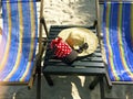 Red cap with white polka dots, straw hat, flowers and sunglasses Royalty Free Stock Photo