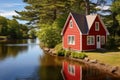 red cape cod house with a side gable roof near a river Royalty Free Stock Photo