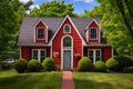 red cape cod with symmetrical dormers surrounded by green trees