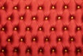 Red capitone with golden buttons texture Royalty Free Stock Photo