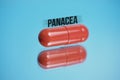 Red capsule with abstract inscription panacea on a blue background