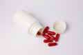 Red capsule white bottle Royalty Free Stock Photo