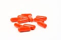 Red Medication Capsules On A White Background