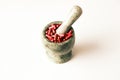 Red capsules and orange pills with mortar pestles on white background. Royalty Free Stock Photo