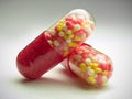 Red capsules over gray Royalty Free Stock Photo