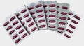 Red capsules pills in blister pack with clipping path . Vitamins and supplements concept Royalty Free Stock Photo