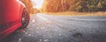 Red car on the autu asphalt road in countryside Royalty Free Stock Photo