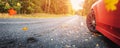 Red car on the autu asphalt road in countryside Royalty Free Stock Photo