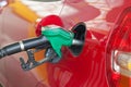 Red car being filled with fuel Royalty Free Stock Photo
