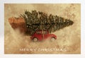 Red car carrying christmas tree grunge style Royalty Free Stock Photo