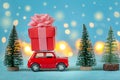 Red car carrying on roof a gift box and Christmas tree on a blue background. Christmas holiday concept Royalty Free Stock Photo