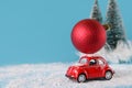 Red car, christmas ball, gift. Delivery transport concept. Christmas holiday celebration concept Royalty Free Stock Photo