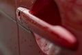 red car door handle with water drops Royalty Free Stock Photo