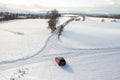 Red Car Driving Down Snow Covered Road, Winter Journey Through Scenic Landscape Royalty Free Stock Photo