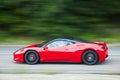 Red car driving fast on country road Royalty Free Stock Photo