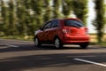 Red car driving at high speed on asphalt road outdoors, motion blur effect Royalty Free Stock Photo