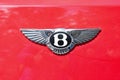 Red car featuring the Bentley logo on its rear, with two chrome wings on the sides Royalty Free Stock Photo