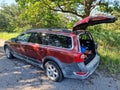 Red car with a flat rear tire. Trunk opened Royalty Free Stock Photo