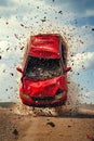 A red car that is flying through the air with a lot of debris coming out of it Royalty Free Stock Photo
