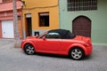 Red car in front of beautiful buildings in a street in Puerto de la Cruz in Tenerife Canary Islands, Spain, Europe