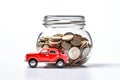 Red car and jar with coins on white background. Auto insurance and car loans, concept of savings money on car purchase. Royalty Free Stock Photo