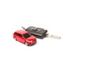 Red toy car and keys isolated on white background