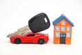 Red car with key with house model. Royalty Free Stock Photo