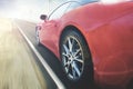 Red car is moving fast on the road Royalty Free Stock Photo