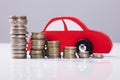 Red Car Over Stacked Coins Royalty Free Stock Photo