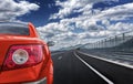 Red car rushing along a high-speed highway. Royalty Free Stock Photo