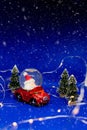 Red car with santa claus. toys over blue background with copy space and xmas decoration. Santa Claus and wooden toy Royalty Free Stock Photo