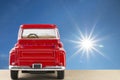 Red car with shining sun at clear blue sky Royalty Free Stock Photo