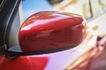 Red car with side rear view mirror on a modern car side mirror front Royalty Free Stock Photo