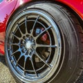 Red car with silver rim on its wheels Royalty Free Stock Photo
