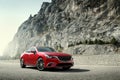 Red car standing on the road near mountains at daytime Royalty Free Stock Photo