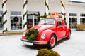 Red car standing in the yard. Volkswagen Beetle on winter day Royalty Free Stock Photo