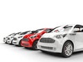 Red Car Stands Out in a Row of White Cars Royalty Free Stock Photo